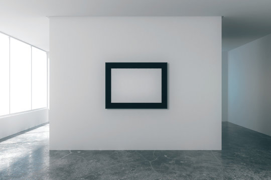 Blank picture frame in empty loft room with white walls, city vi