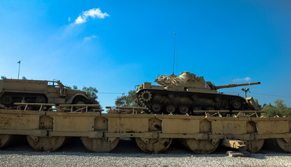 Fototapeta na wymiar M60 Patton Tank with M9 Dozer Blade and M3 half-track carrier on Pontoon bridge