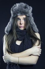 Portrait of frozen girl on black background