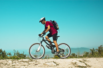 Naklejka na ściany i meble Cyclist on a mountain bike