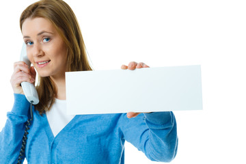 attractive young woman with blank ad banner and telephone