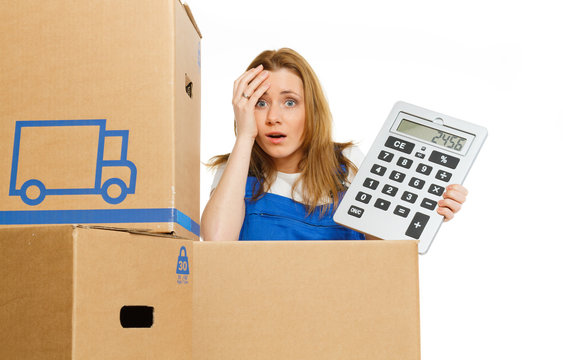 Woman with moving boxes with big calculator