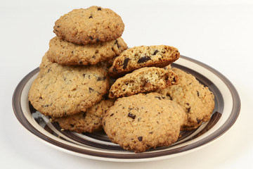 Oatmeal cookies with chocolate on crockery plate