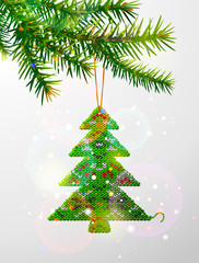 Christmas tree branch with hanging knitted pine as bauble