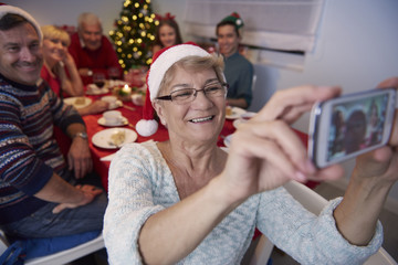 Grandmother taking photo of the whole family.