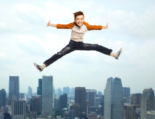 Fototapeta na wymiar happy smiling boy jumping in air