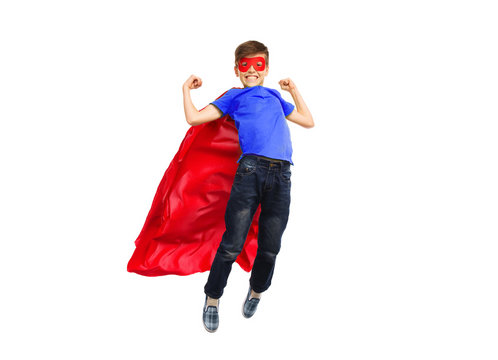 boy in red super hero cape and mask flying on air