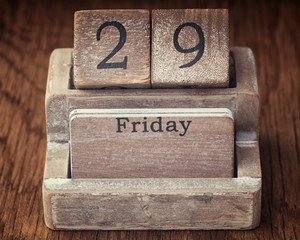 Grunge calendar showing Friday the twenty ninth on wood background