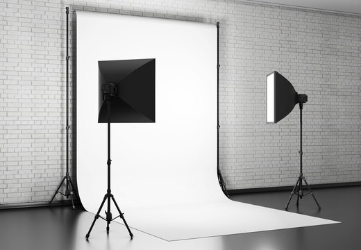 White background lit with Studio equipment against a brick wall.