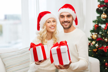 happy couple at home with christmas gift boxes
