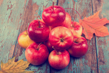 Fresh apples and autumn maple leaf.