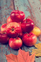 Fresh apples and autumn maple leaf.