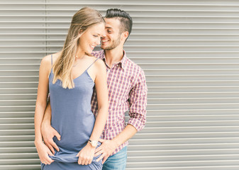 Naklejka premium Happy couple posing against a steel background