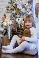 Happy girl with toy bear. Christmas.