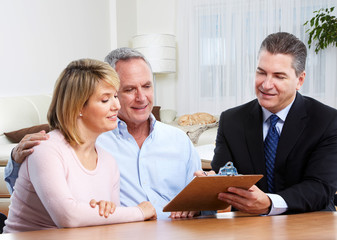 Senior couple with real estate agent.