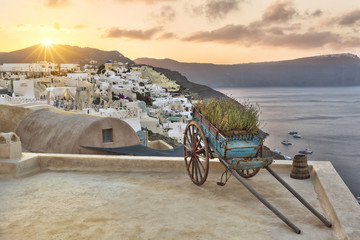 Cart on a roof terrace in Oia at rising sun