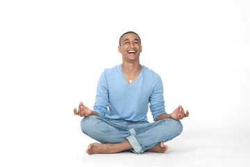 Young man in casual sitting in the lotus position over white background