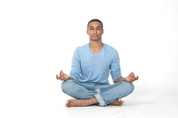Young man in casual sitting in the lotus position over white background