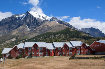 czerwone domki na tle gór Patagonii