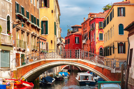 Colorful lateral canal and bridge in Venice, Italy