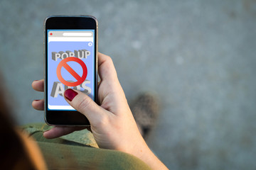 Woman walking smartphone interface ads blocker