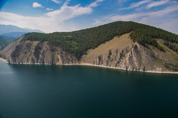 Obraz na płótnie Canvas Wild coast with mountains and forest from the air