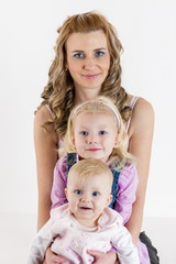 portrait of mother with her baby and daughter
