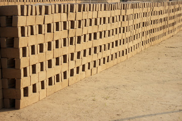 Pattern of bricks. Mud brick before burning on a workshop in India.