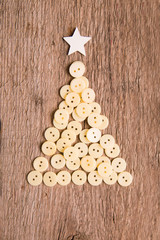 buttons as decorative Christmas tree on wooden