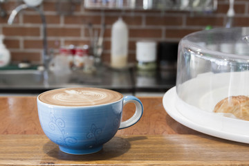Close up blue cup of Coffee, latte on the wooden table