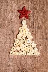 buttons as decorative Christmas tree on wooden