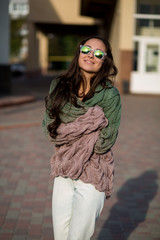 Obraz premium Beautiful young brunette girl walking down the street