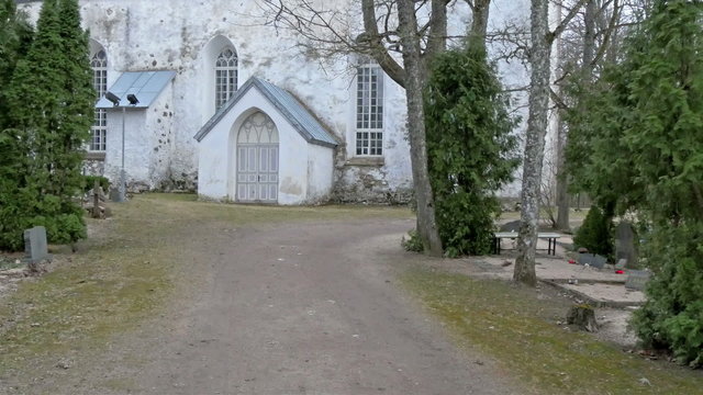 Getting inside the gate of the church. It is a white church with a small door in front