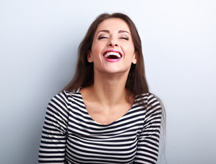 Happy natural laughing young casual woman with wide open mouth a