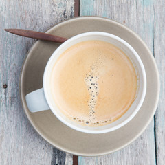 Top view of a cup of coffee on wooden table