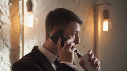 Man using an advanced personal vaporizer or e-cigarette
