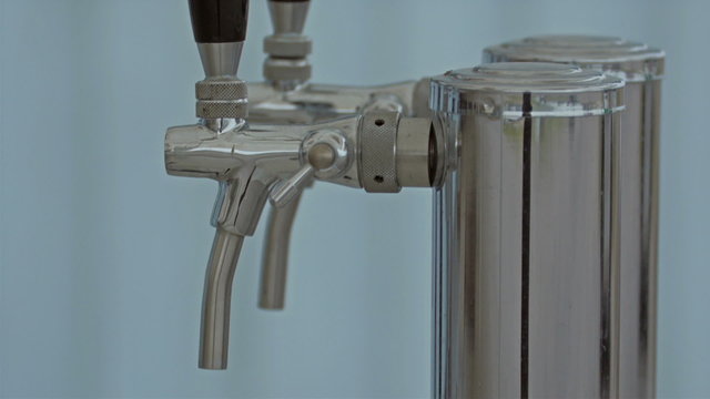 Two silver faucet on the sink in the fod. The faucet has black rubber on it on top