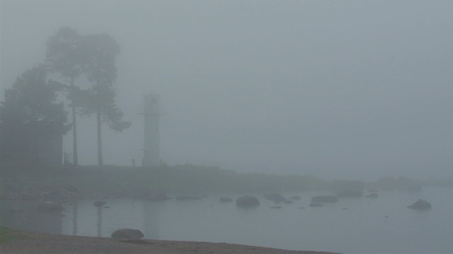 The small port or fod in a town with fogs around. The area has a pathway towards the sea