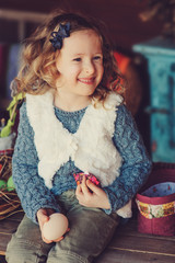 happy child girl preparing for easter at cozy wooden country house