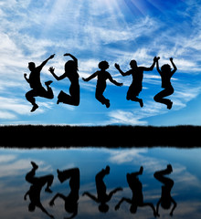  Silhouette of a happy group of people jumping