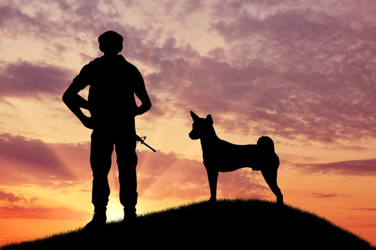 Silhouette of soldiers with weapons and dogs