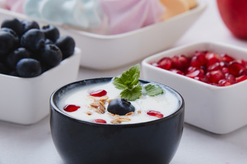 yogurt with cereals, blueberry and pomegranate