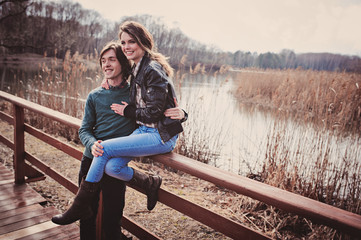 young loving happy couple on cozy warm outdoor walk on country side