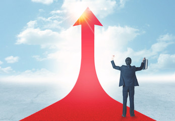 businessman standing on a red arrow