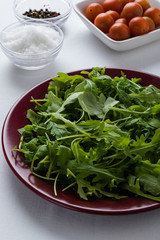 rucola salad on red plate