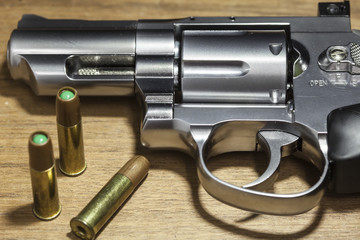 close -up air gun on old wood background.