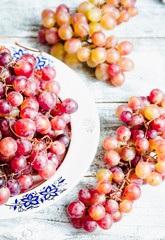 Fresh red grapes on the plate, raw fruits, whole plant foods