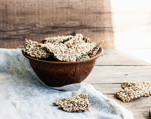 crackers from flax seed, sesame, sunflower and spices on a dark