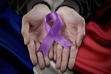 Holding purple domestic violence awareness ribbon