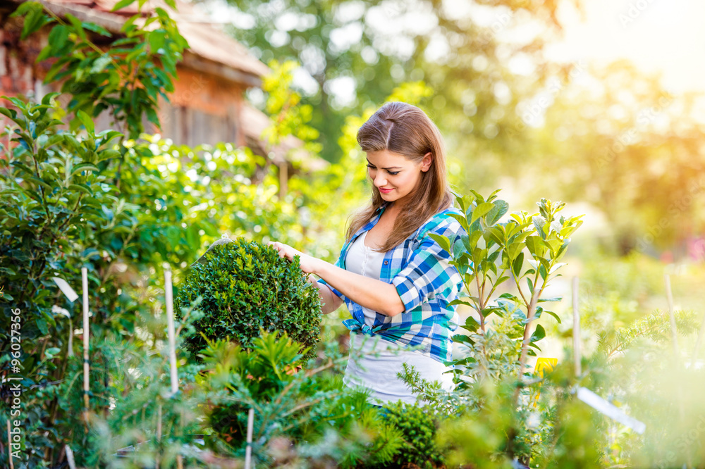 Wall mural beautiful young woman gardening